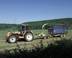 Busy in the fields near Alcester a tractor cutting its crop in the sunshine. 1998 Busy in the fields near Alcester a tractor cutting its crop in the sunshine. 1998