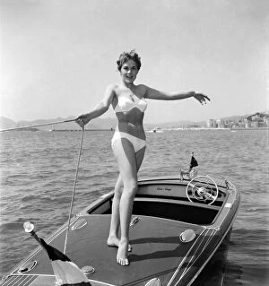 Cannes Film Festival 1953. Lise Michaud seen here modeling a bikini on a speed boat just