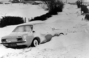 A car is left in a deep snow drift on the road from Culverhouse Cross to St Lythans near A car is left in a deep snow drift on the road from Culverhouse Cross to St Lythans near