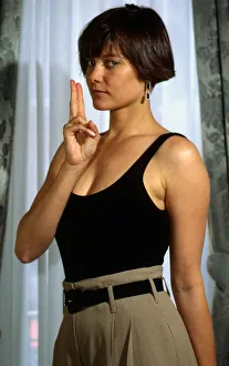 Carey Lowell holding up fingers in gun pose 1989 Carey Lowell holding up fingers in gun pose 1989