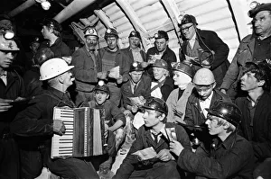 Carol service by miners 600 ft down. An accordion play and miners voices are raised in Carol service by miners 600 ft down. An accordion play and miners voices are raised in