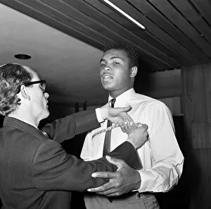 The Peoples Champion Gallery: Cassius Clay aka (Muhammad Ali) getting measured at Austin Reeds in London'