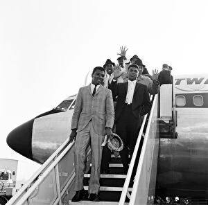 The Peoples Champion Gallery: Cassius Clay aka (Muhammad Ali right) arriving at London Airport with brother Rudolph