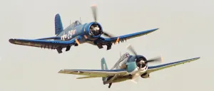 The Chance Vought F4U Corsair seen here flying in formation with a Grumman F6F Hellcat The Chance Vought F4U Corsair seen here flying in formation with a Grumman F6F Hellcat