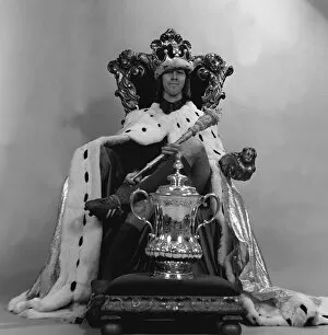 Images Dated 30th April 1972: Charlie George sits on the throne as king with FA cup 1972