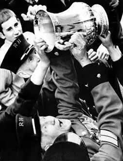 Images Dated 1st May 1970: Chelsea Pensioners get a hand on the FA Cup as Dave Webb hands it to them during