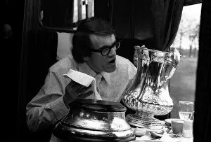 Images Dated 30th April 1970: Chelseas Eddie MaCreadie on his way back to London on the train polishes up the FA