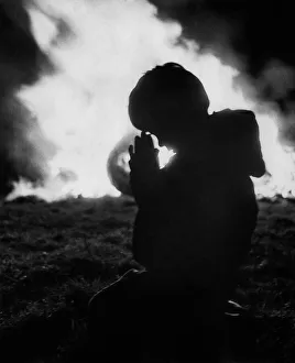 Images Dated 20th December 1970: A child prays against the flames of the Bonfire at Stewkley. December 1970 P000327