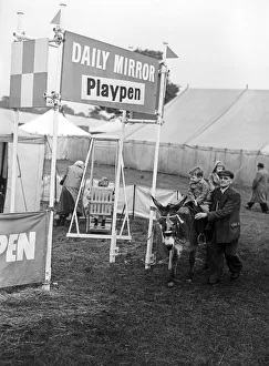 A child riding on a donkey past the Daily Mirror Playpen at Altrincham agriculture show A child riding on a donkey past the Daily Mirror Playpen at Altrincham agriculture show