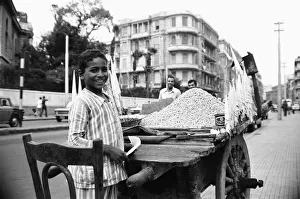 A child street vendor selling chick peas on the streets of Alexandria. 29th May 1976 A child street vendor selling chick peas on the streets of Alexandria. 29th May 1976