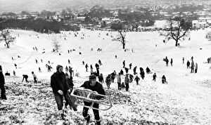 Children and adults playing in the snow on the Lickey Hills in Birmingham. 28 / 12 / 1970