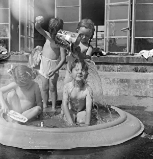 Children of Alexandra Day Nursery near Loch Lomond, Scotland cool off in a portable Children of Alexandra Day Nursery near Loch Lomond, Scotland cool off in a portable