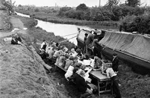 Children of barge family's seen here being educated on the canal bank by a floating Children of barge family's seen here being educated on the canal bank by a floating