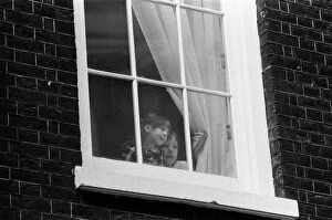 Images Dated 18th March 1986: The children of Chancellor of the Exchequer Nigel Lawson watching from a window of 11