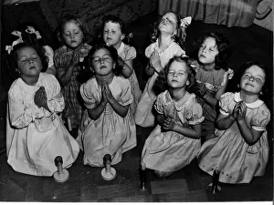 Children kneeling saying prayers. Circa 1940s Children kneeling saying prayers. Circa 1940s