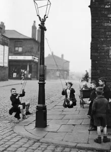 Children in a Manchester Street find their own enjoyment with the aid of a rope Children in a Manchester Street find their own enjoyment with the aid of a rope
