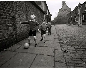 Children playing football on the streets of Manchester in England May 1967 Children playing football on the streets of Manchester in England May 1967