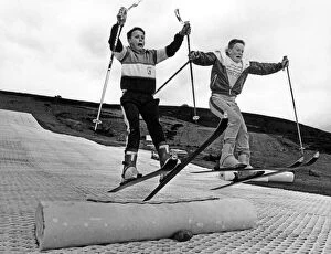 Children practising their ski-jumps on their self made jumps while the permanent jumps