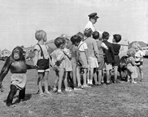 00140 Gallery: Children queue with their Chimpanzee friend for an ice cream at Billy Smart Circus