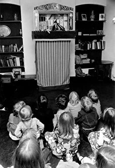 Children sitting on the floor watching the Pinch and Judy puppet show at a party