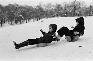 Children sledging on washing up bowls in Greenwich Park, London, 27th December 1970