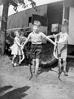 00192 Gallery: Children unloading a racing sulky, the light frame the jockey rides in during a trotting