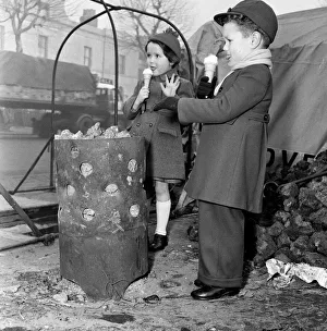 Children warming themselves round the watchman's fire. 5th January 1956 Children warming themselves round the watchman's fire. 5th January 1956