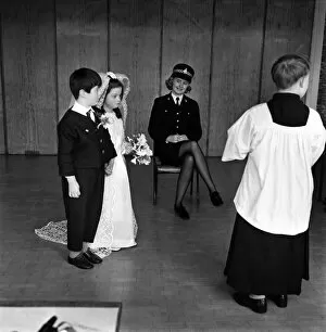 Images Dated 19th March 1970: Children wedding has police guard: Police guard for child bride wearing Pilkington
