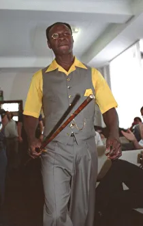 Chris Eubank Boxing in grey waist coat and trousers and yellow short sleeve shirt struts Chris Eubank Boxing in grey waist coat and trousers and yellow short sleeve shirt struts