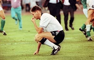 Chris Waddle Football crouches down with his head in his hand after missing a penalty in