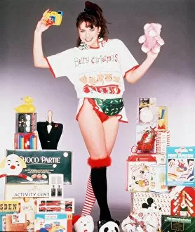 Images Dated 5th December 1989: Christmas model surrounded with present ideas for Christmas, 5th December 1989