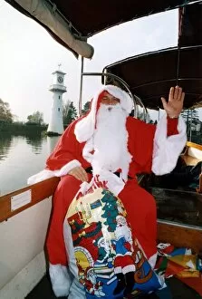 Images Dated 20th December 1998: Christmas - Santa takes a trip across Roath Park Lake, Cardiff - Dec 1998