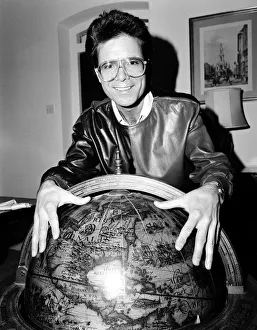 Cliff Richard with a globe. 5th January 1984 Cliff Richard with a globe. 5th January 1984