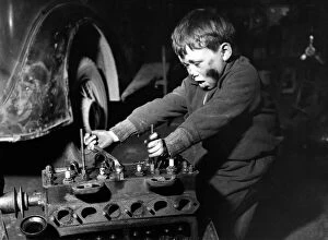 00611 Gallery: Clockwork? Huh, Kids Stuff! 6 year old David Redford working on a car in his foster