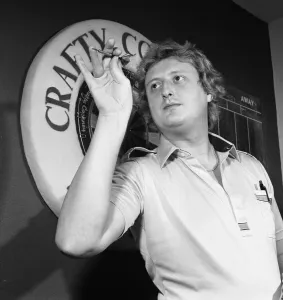 Close up feature on British darts player Eric Bristow in dart throwing action Close up feature on British darts player Eric Bristow in dart throwing action