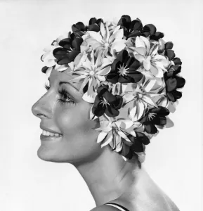 Clothing Beach. Woman models swimming hat covered in flowers Clothing Beach. Woman models swimming hat covered in flowers