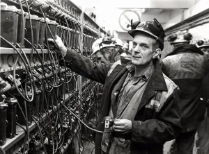 Coal - Miners - Coal miner checks his lamp in at the lamp room at a South Wales Colliery Coal - Miners - Coal miner checks his lamp in at the lamp room at a South Wales Colliery