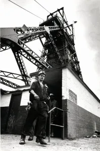 Coal - Miners - General mining shot showing a miner with the winding gear in Coal - Miners - General mining shot showing a miner with the winding gear in