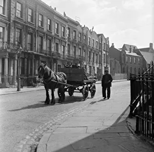 Coalman Mr Nightingale delivering coal. 25th April 1955 Coalman Mr Nightingale delivering coal. 25th April 1955