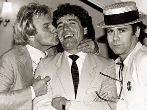Famous People Gallery: Comedian Freddie Starr kisses England striker Kevin Keegan as Pop star Elton John looks
