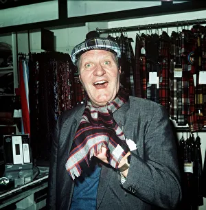 Images Dated 4th October 1974: Comedian Tommy Cooper in a tartan shop 1974