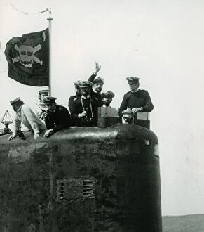 The conning tower of HMS Conqueror with the captain and crew members flying the jolly