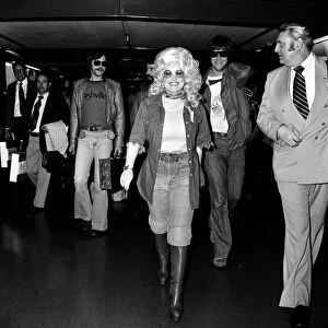 Country & Western singer Dolly Parton arriving at London Heathrow Airport, 16th May 1977