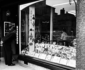 A couple looking in the window of The Old Tudor House Gift and Souvenir Shop A couple looking in the window of The Old Tudor House Gift and Souvenir Shop