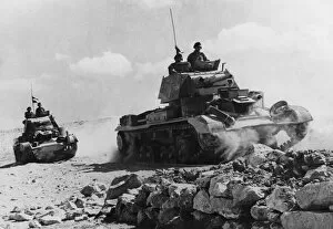 Tobruk Collection: Cruiser tanks moving into action over rough ground near Tobruk during Second World War