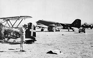 Airfields Gallery: Dakota transport planes being unloaded on a captured airfield in southern Italy during