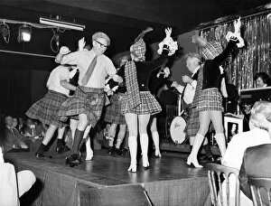 Dancing girls in mini-kilts and sporrans performing at the Caledonian Suite night club