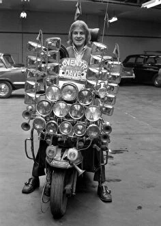 Images Dated 1st March 1971: Dave Lewis(17), of Coventry sits on his very distinctive scooter which has 12 headlamps