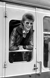 00163 Collection: David Bowie leaning out of a railway carriage of the Paris boat train at Victoria station