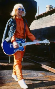 Debbie Harry January 1980 Holding guitar sun glasses orange suit blue denim jacket Debbie Harry January 1980 Holding guitar sun glasses orange suit blue denim jacket